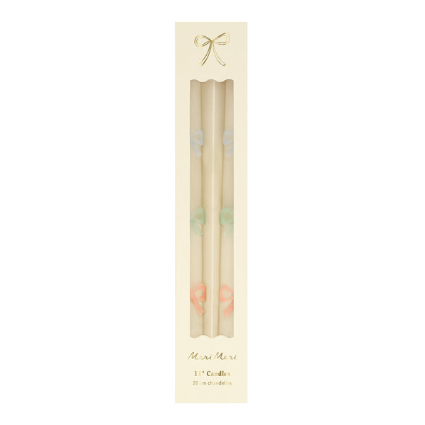 Our party candles, crafted in a tapered shape with embossed and handpainted pastel bows, have mint green wicks. Image5