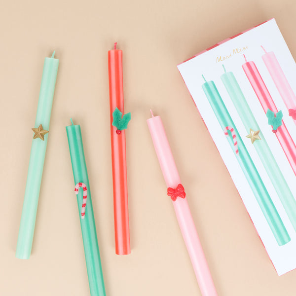 Our tall Christmas candles feature 4 different seasonal stripes teamed with wax festive icons and colored wicks for a stylish look. Image1