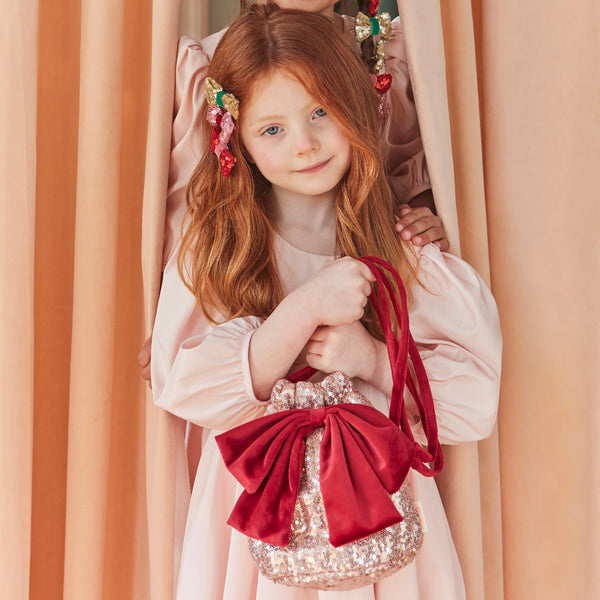Our Christmas bag is the perfect accessory for Christmas dress up, with pink sequinned tulled and a big red velvet bow. Image2