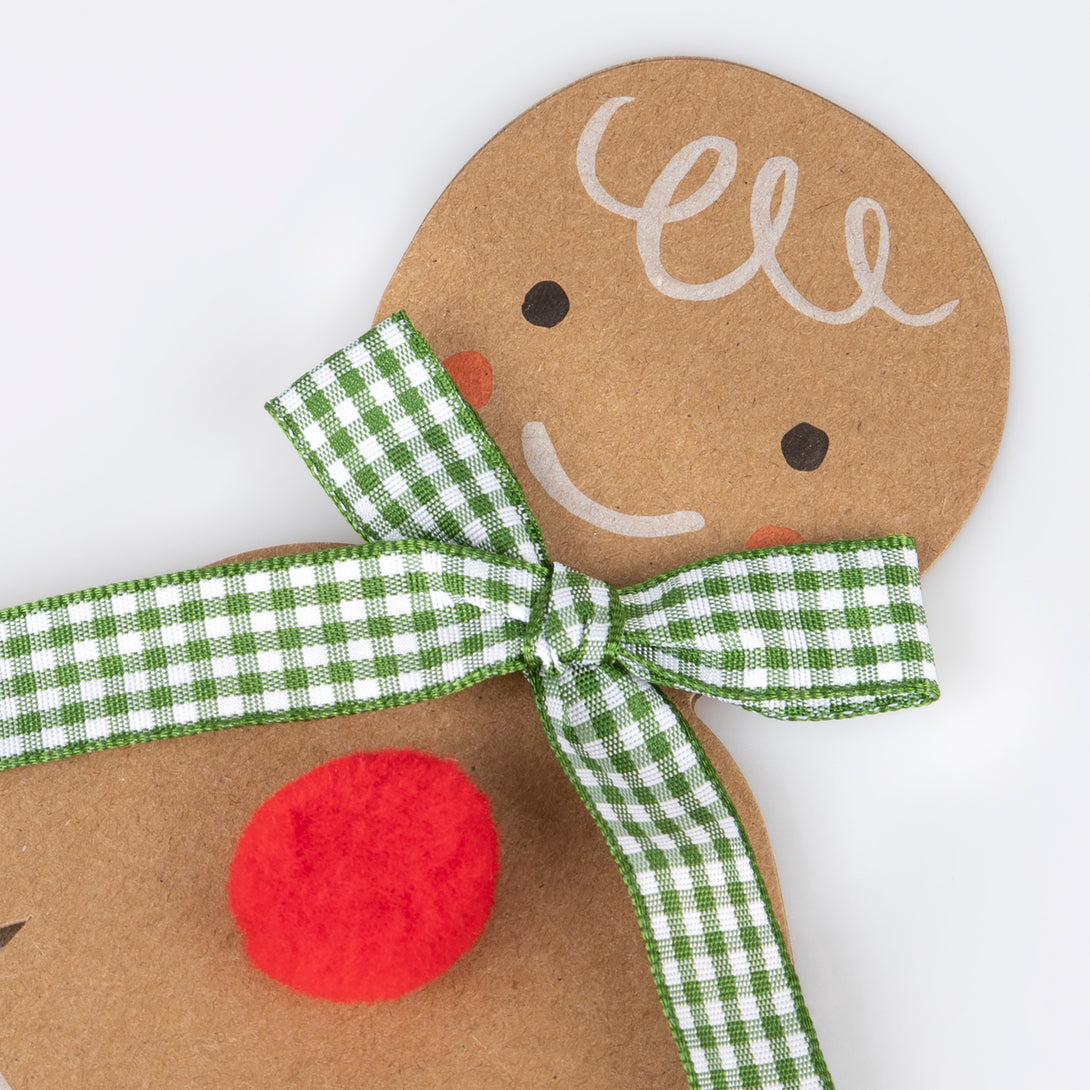 Our Christmas card, in the shape of a gingerbread man with a gingham ribbon bow, makes a great Christmas mantel decoration.