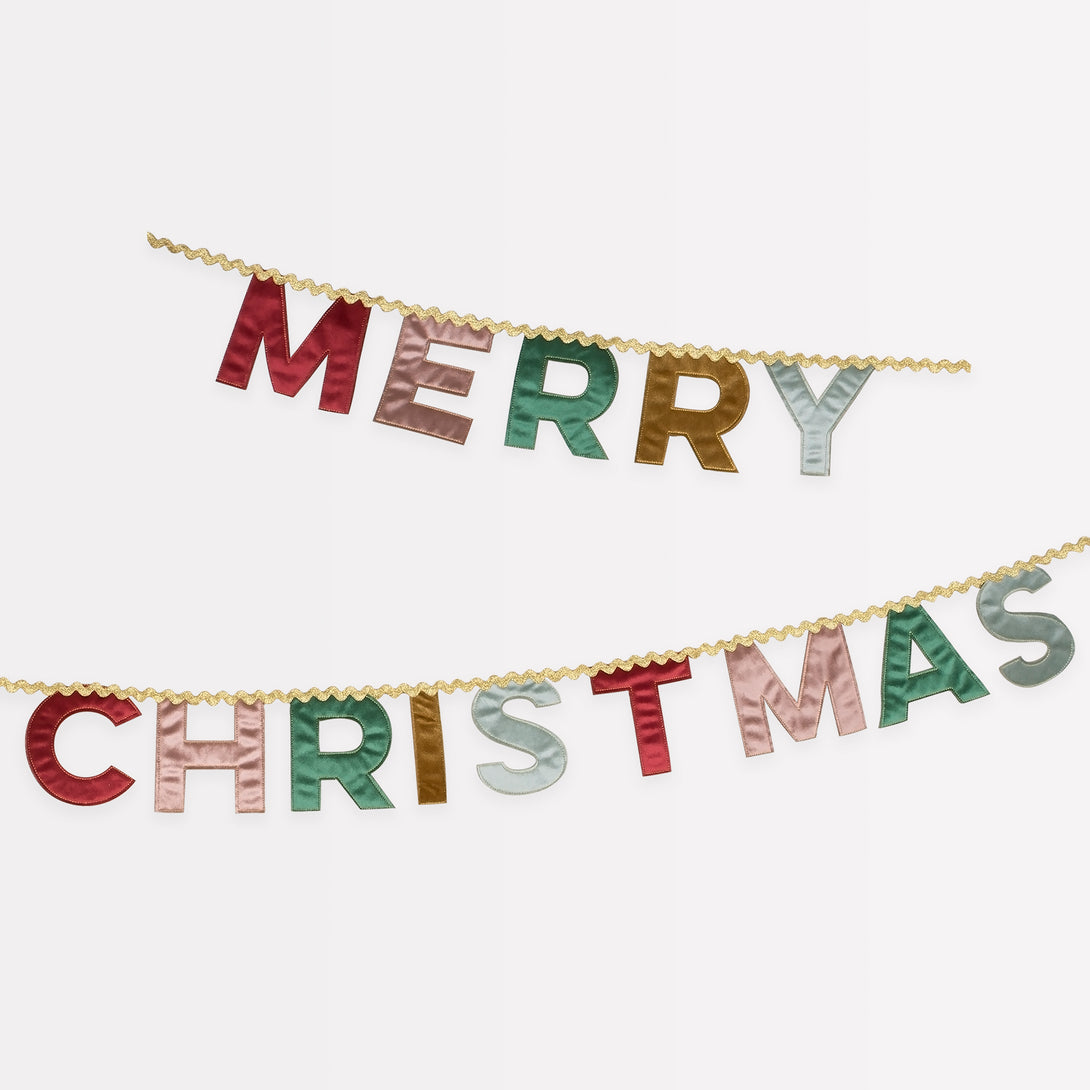 Our Merry Christmas garland is made in velvet with a mix of traditional and modern colors and metallic gold ric rac.