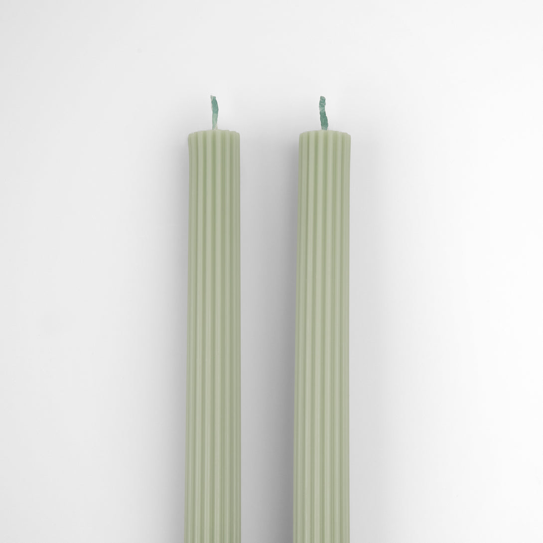 Our table candles, long with ridged details, are in a gorgeous green shade.