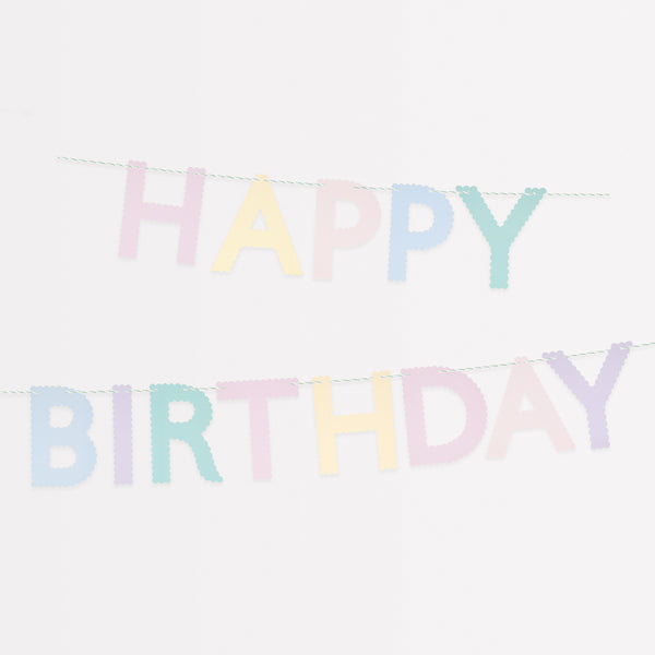 Our paper garland, with the words Happy Birthday in pastel scalloped letters, is the perfect birthday party decoration.