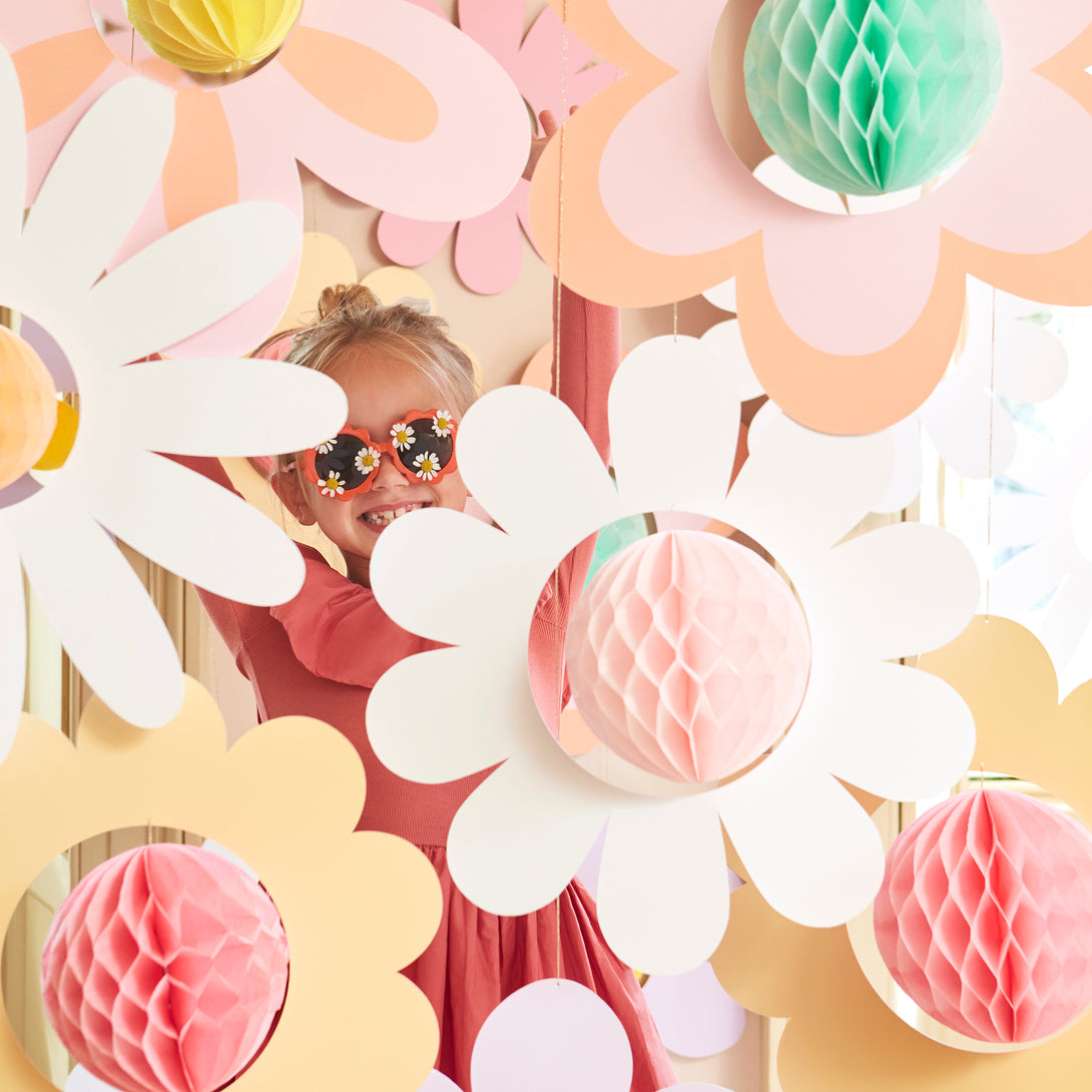 Our flower hanging decorations, with 3D honeycomb centers, are perfect for a pink party, groovy party or summer party