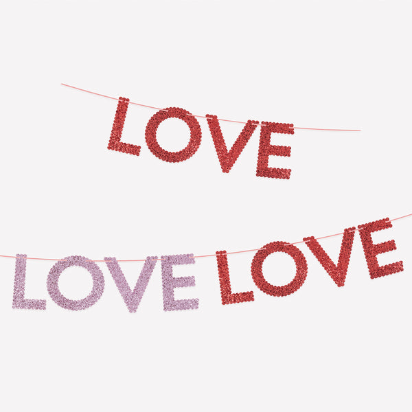 Our Valentine's Day garland features chunky pink and red glitter fabric letters to spell out the word love three times, vibrant and stylish. Image1