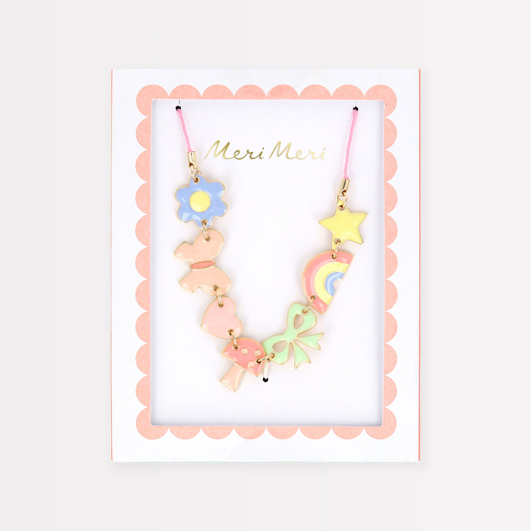 Our charms necklace is crafted with colorful enamel charms with a pink cord and gold tone lobster clasp, a pretty necklace for kids.