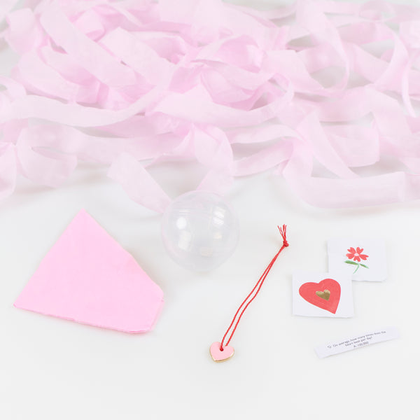 Our surprise balls with velvet bows contain a party hat, stickers, a joke and a heart charm, and make stylish Valentine's Day party favors. Image3