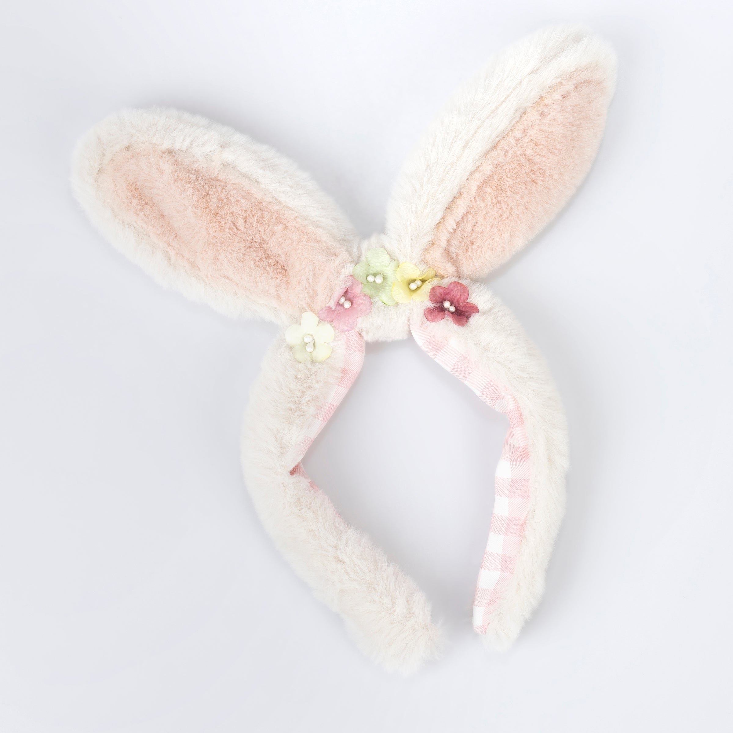 Our Easter costume, a set of bunny ears and tail, is made from plush fabric and presented in a gingham bag.