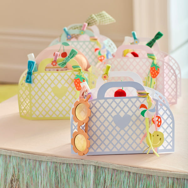 Our party favor bags are designed to look like little baskets, in pink, blue, mint and yellow, complete with paper charms tied on with ribbons. Image2