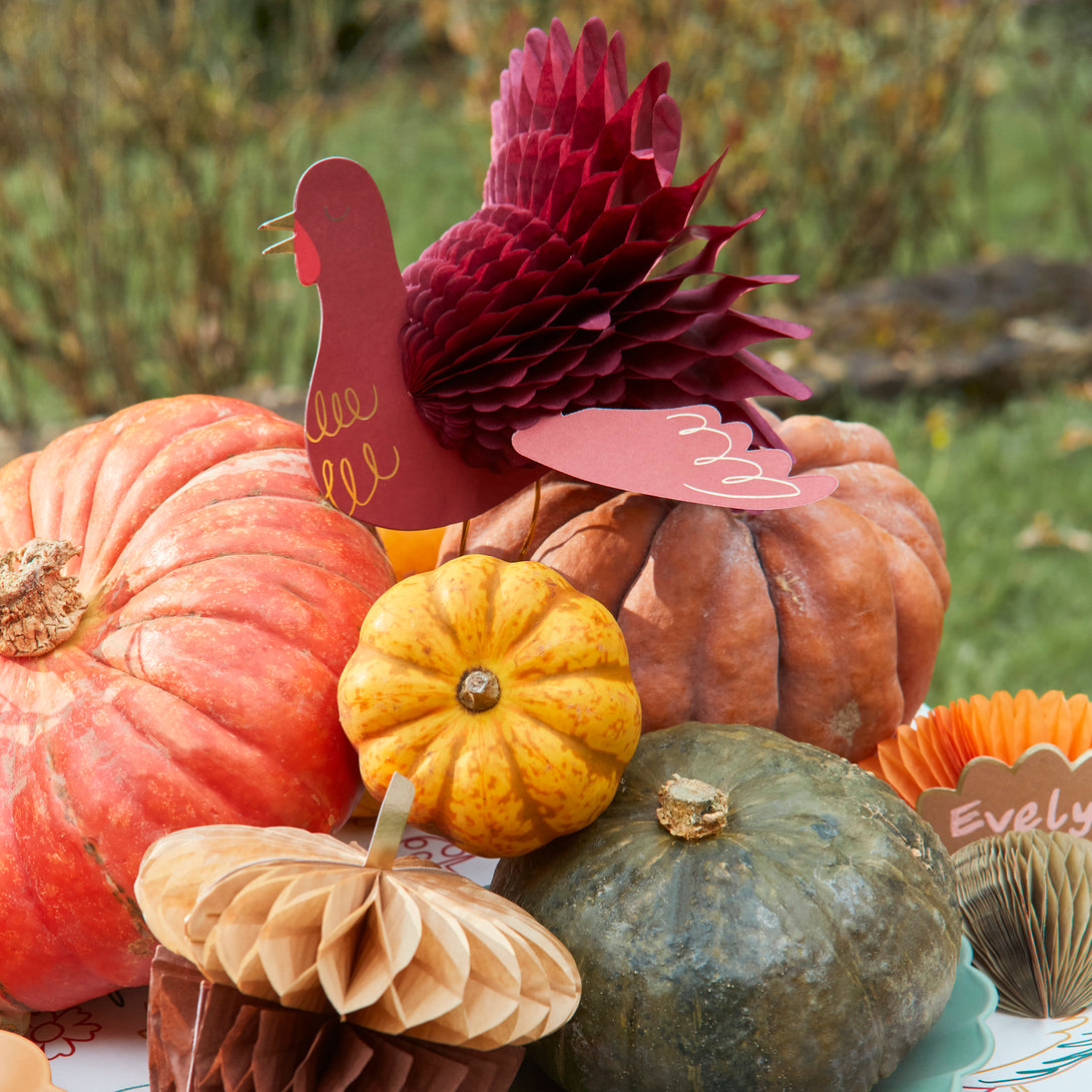 Our Thanksgiving table decorations include honeycomb turkeys, pumpkins, mushrooms and acorns.