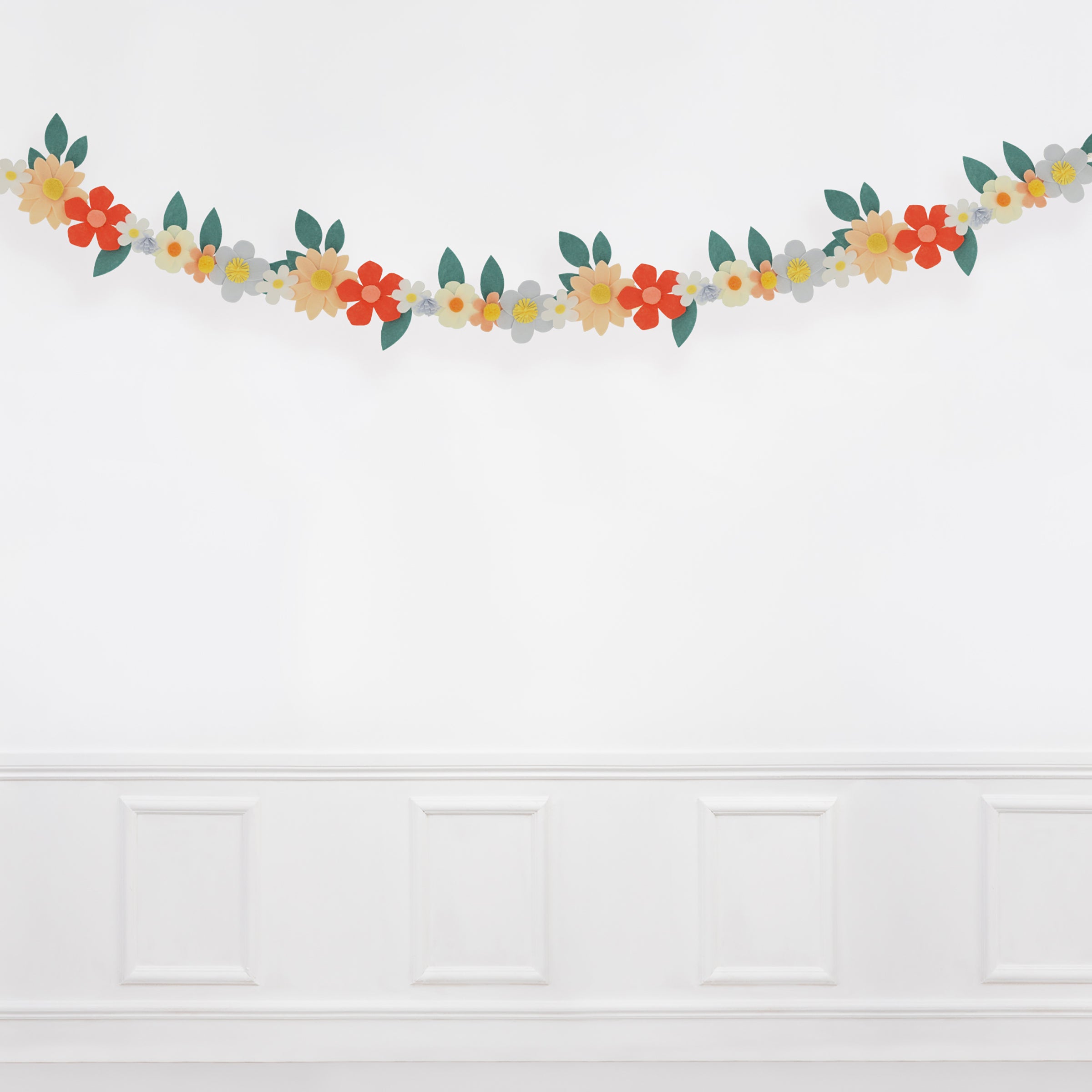 Our special party garland is crafted from felt, with flowers with pompom centers.