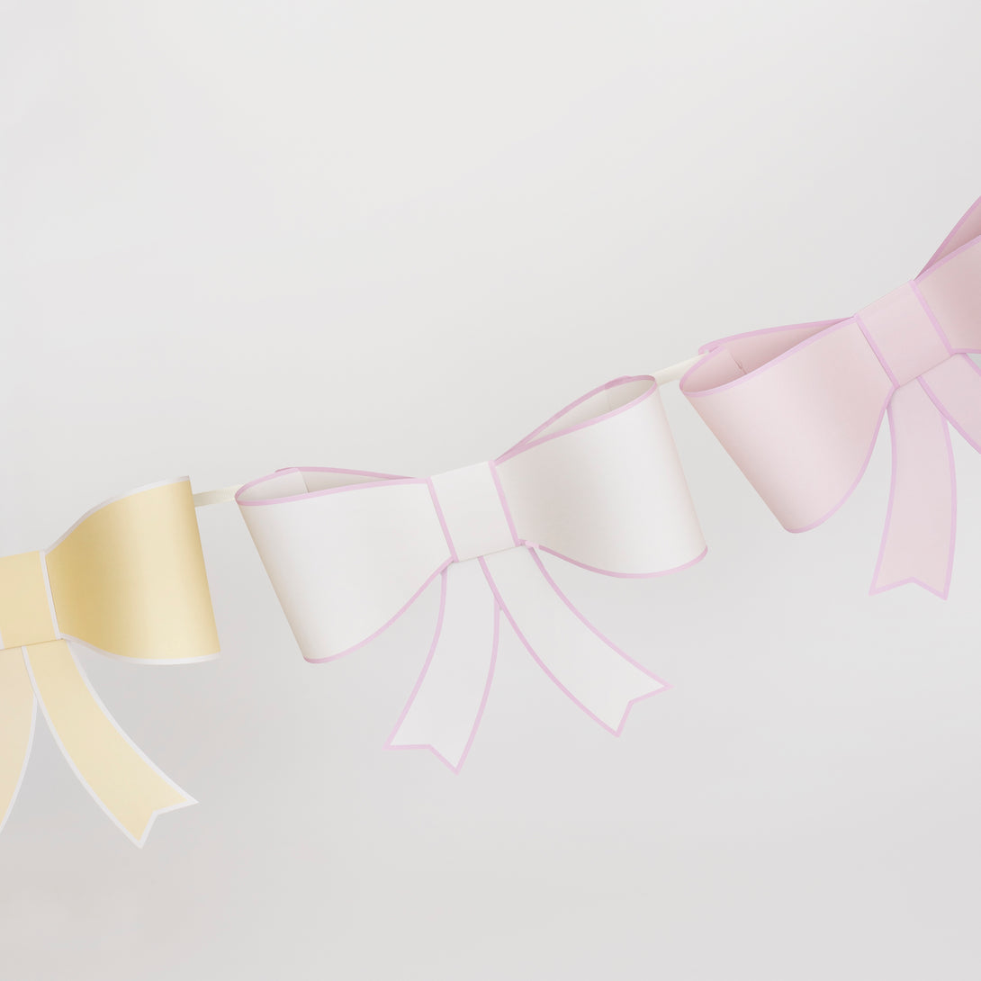 Our large garland, with big bows in soft colors, is perfect as a wall decoration.