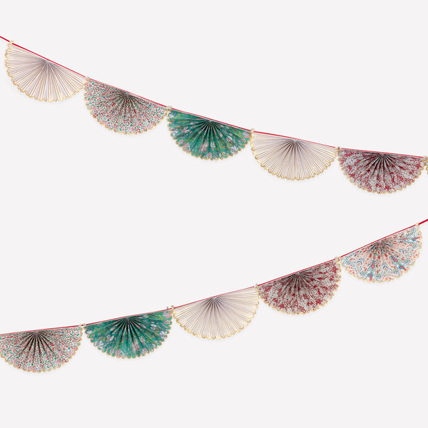 Our elegant Christmas garland has Liberty prints and matte gold foil details, pre-threaded on to a stylish red velvet ribbon. Image1