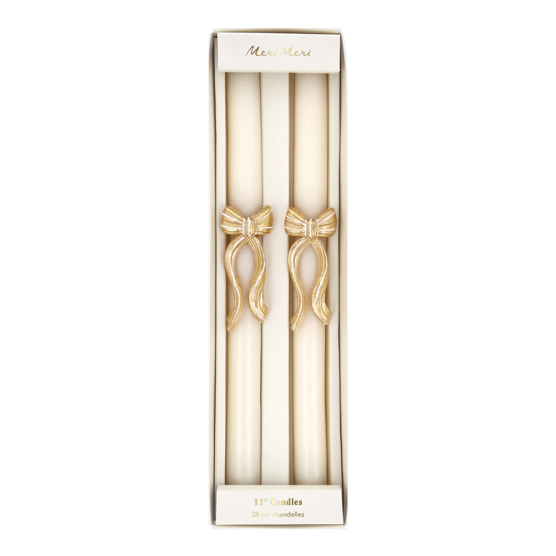 Our golden Christmas host gift set includes two table candles, with gold stripy bow details, and a pack of paper napkins with gold bow designs. Image6