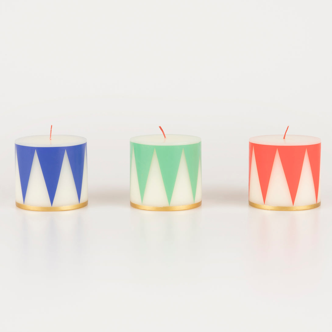 Our Christmas candle set of 3 candles have traditional Nutcracker designs of red, green and blue, with gold details and red wicks.