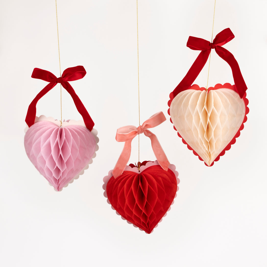 Our Valentine's hanging decorations, 3D honeycomb hearts in pink, red and cream with velvet ribbons, are perfect to set the scene for love