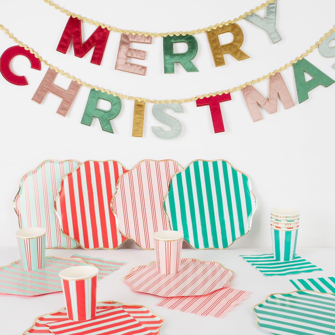 Our Christmas party set includes striped paper plates, cups and napkins, and a luxury velvet garland.