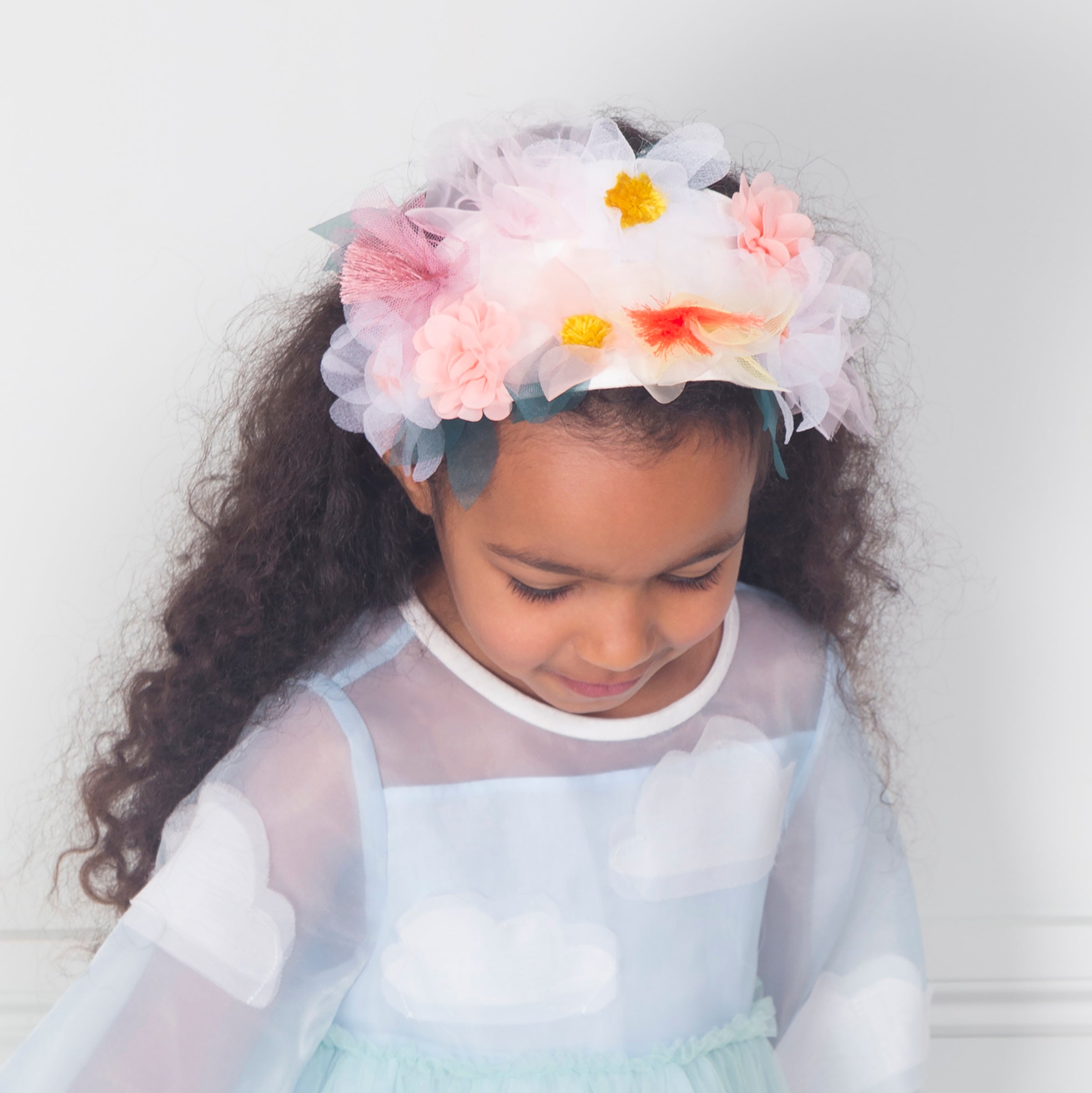 Our summery headband is embellished with organza flowers.