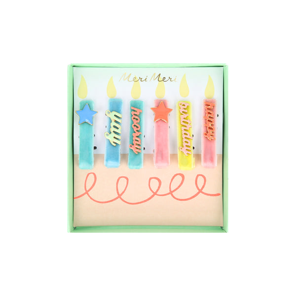 Our hair accessories for kids are charming birthday candle shaped clips with velvet ribbon and enamel details.