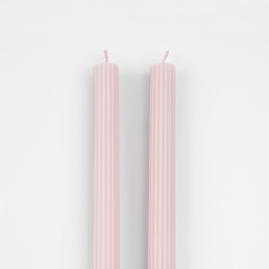 Our tall candles, in a pink color with ridged details, add a stunning look to any party.