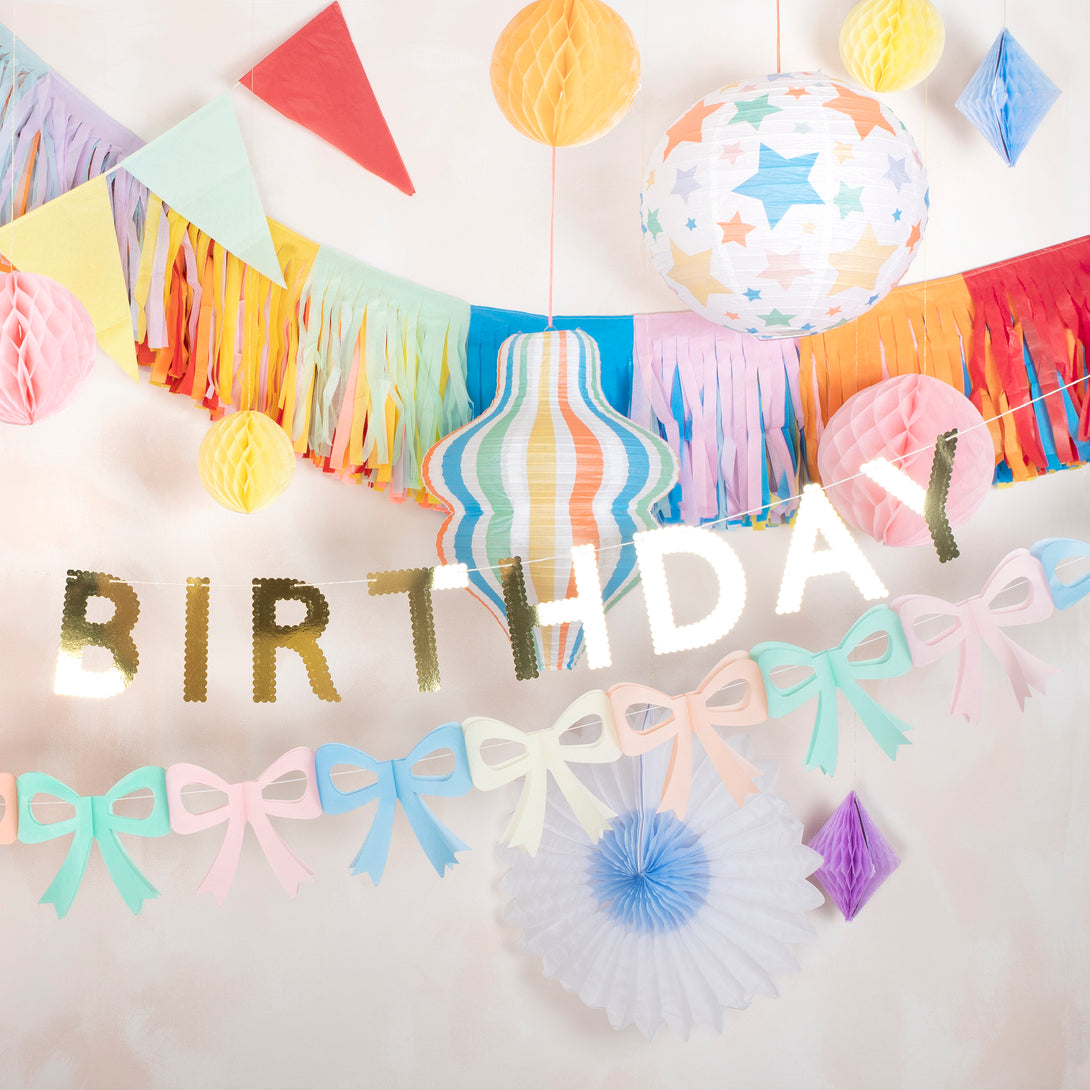 Our paper garland set includes 2 flag garlands in 10 bright colors, ideal for birthday party decorations.