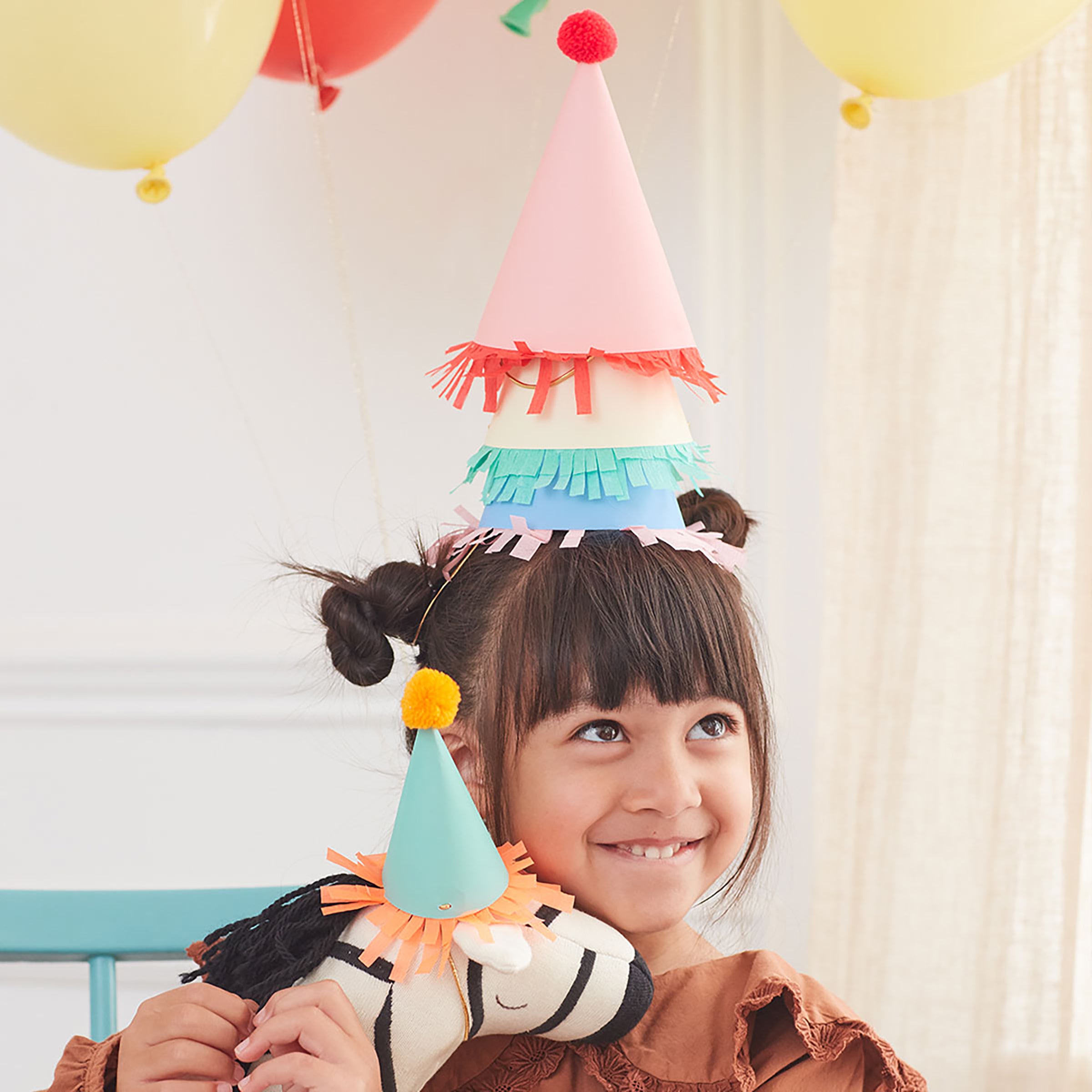 Our paper hats feature fringing, pompoms and bright colors.