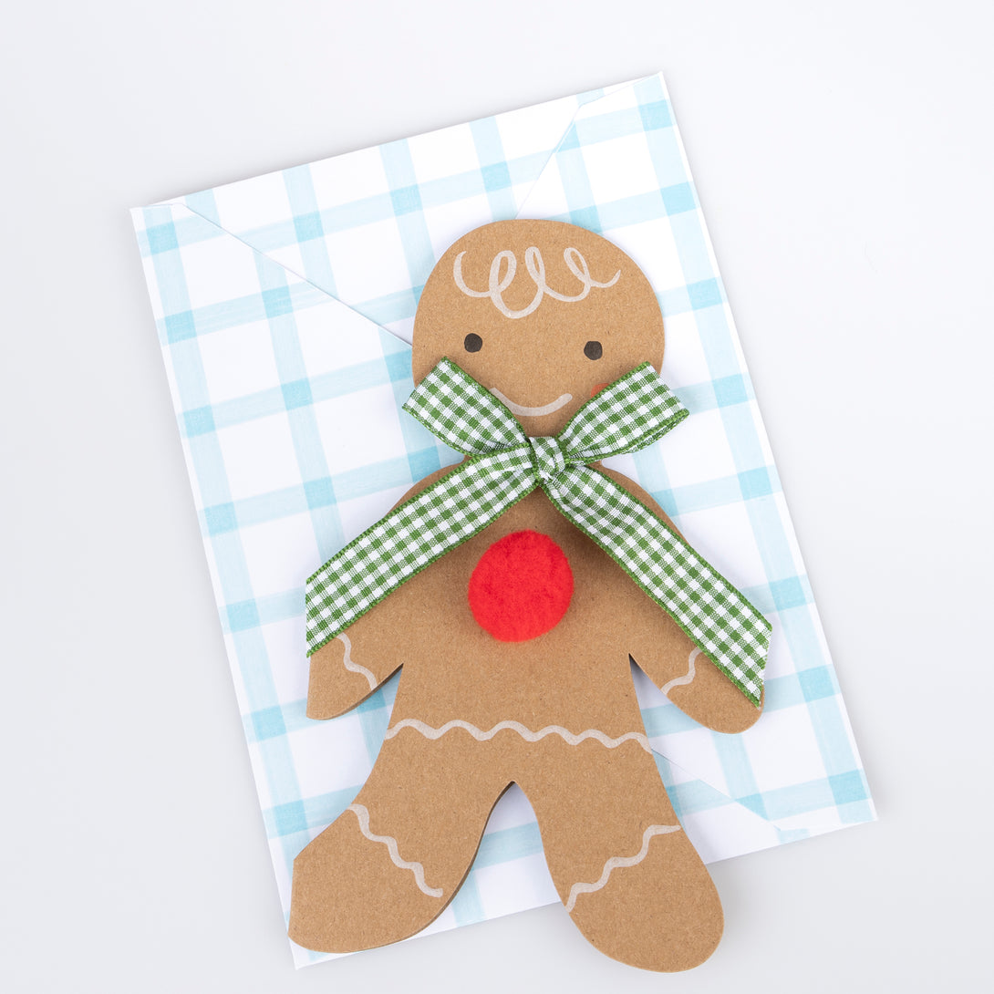 Our Christmas card, in the shape of a gingerbread man with a gingham ribbon bow, makes a great Christmas mantel decoration.