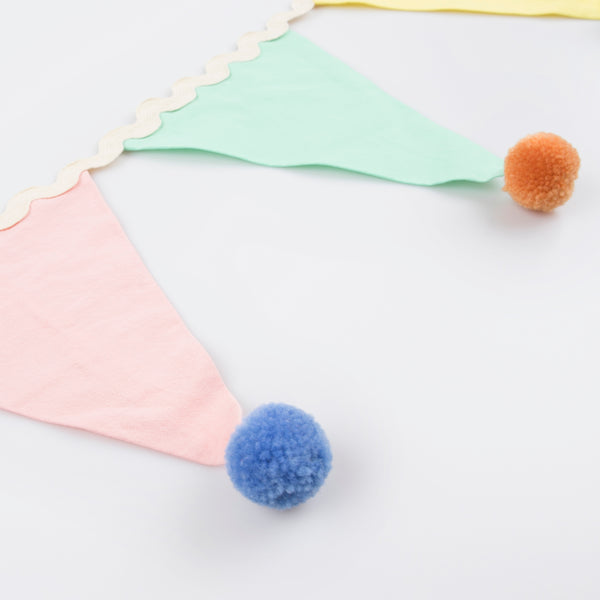 Add a pop of pastel color to your party table or wall with our flag garland with pompoms. Image5