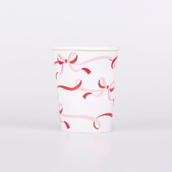 Our Christmas party cups, with a stylish bow design in red, pink and gold are ideal for festive drinks and table decoration. Image1