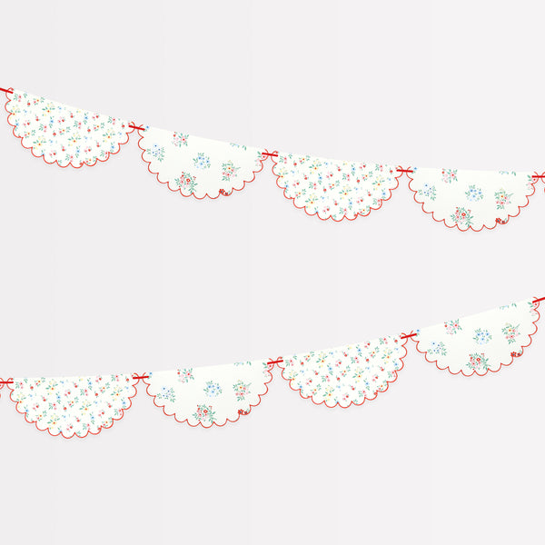 Our paper garland features pretty floral designs and a red ribbon, ideal as a baby shower garland, for bridal showers or garden parties.