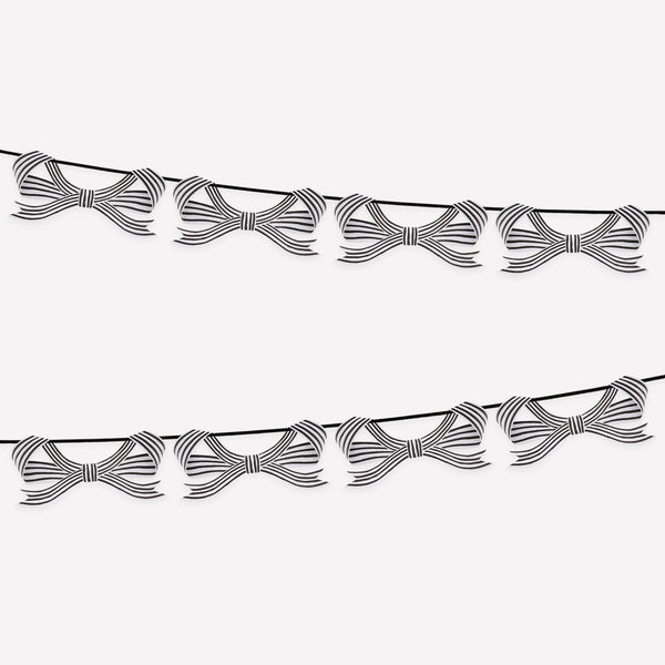 Our paper garland is perfect to add to your Halloween hanging decorations, with black and striped bows it's eerily stylish. Image1