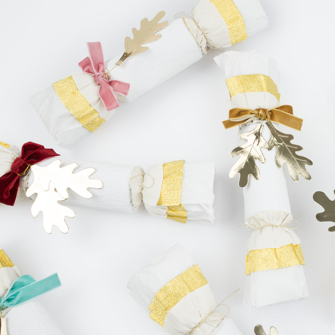 Our Thanksgiving crackers are made with crepe paper, golden leaves and velvet bows, and each have a luxury gift of a brooch or keyring.