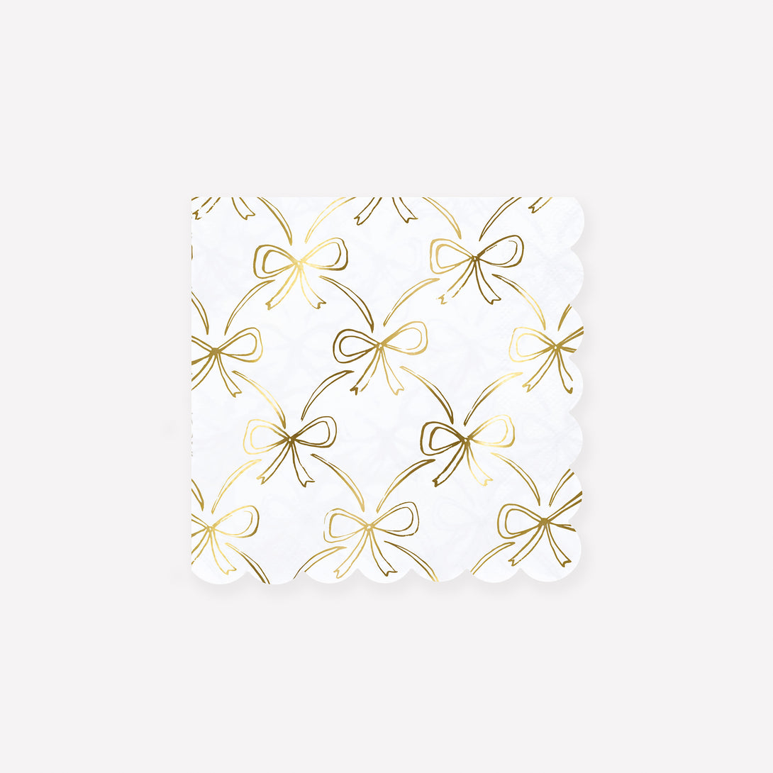Our golden Christmas host gift set includes two table candles, with gold stripy bow details, and a pack of paper napkins with gold bow designs. Image7