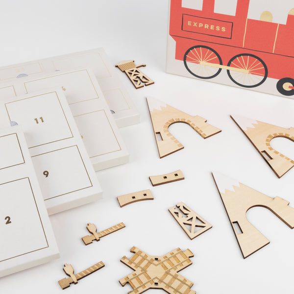 This kids advent calendar is presented in a mini suitcase which contains wooden trains. Image3