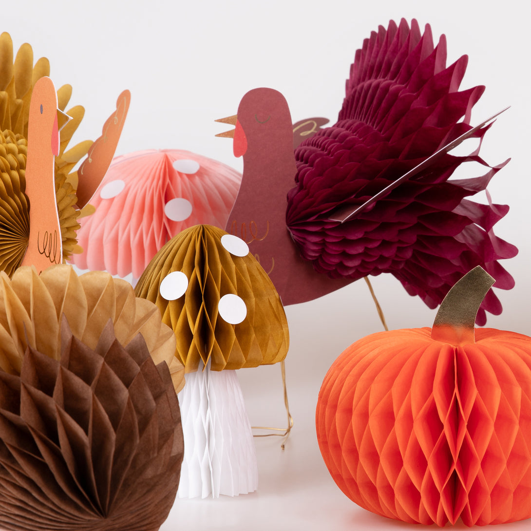 Our Thanksgiving table decorations include honeycomb turkeys, pumpkins, mushrooms and acorns.