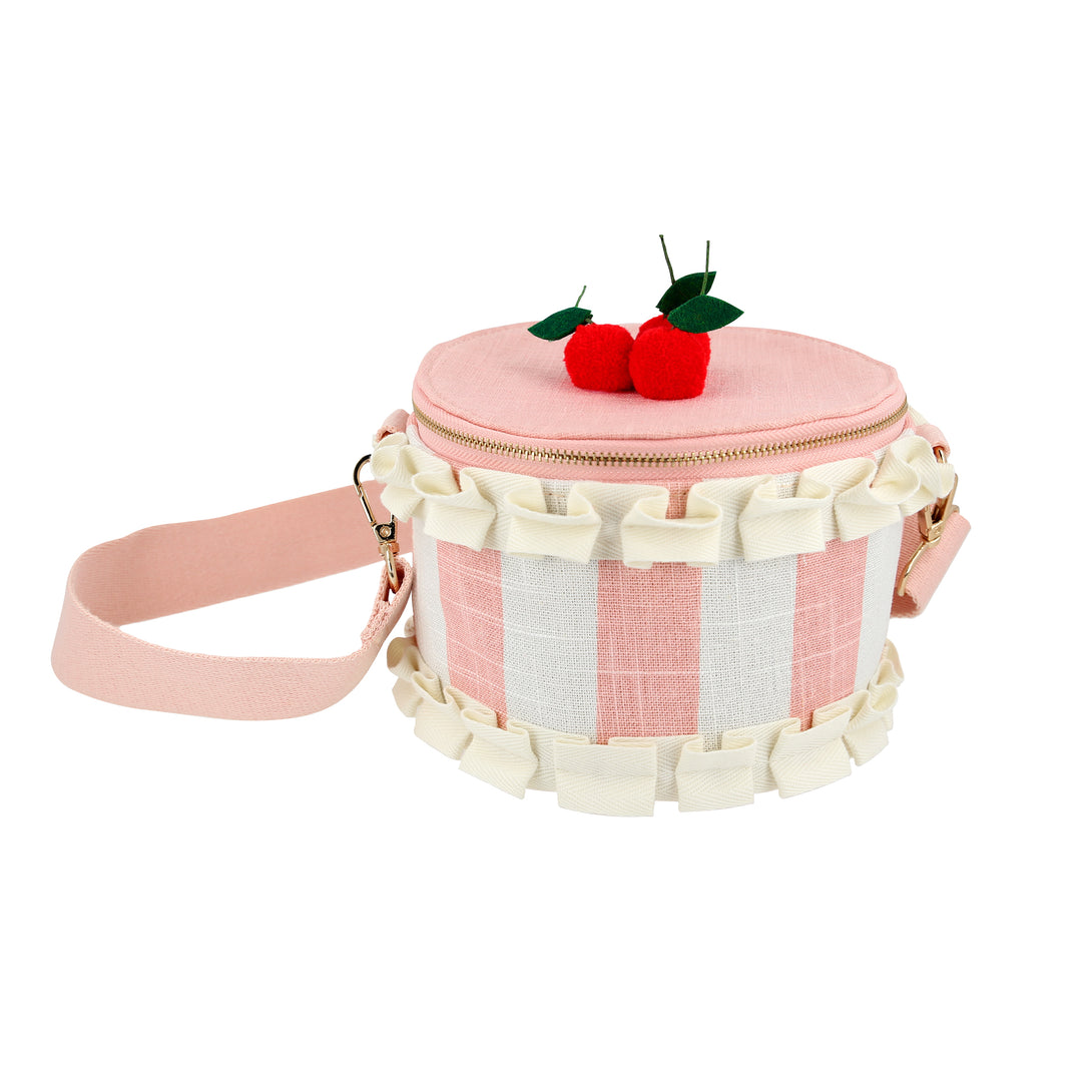 Our pink fabric bag, crafted to look like a cake, features fun pompom cherries, felt leaves, a ruffled ribbon and a long webbing handle.