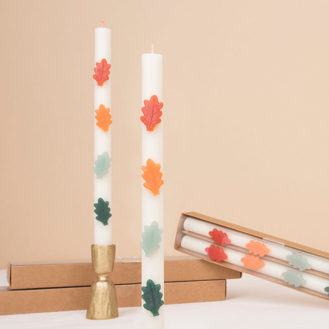 Our decorative candles, featuring wax leaves and colored wicks, are perfect to add a touch of beauty to your dinner table or mantel. Image1