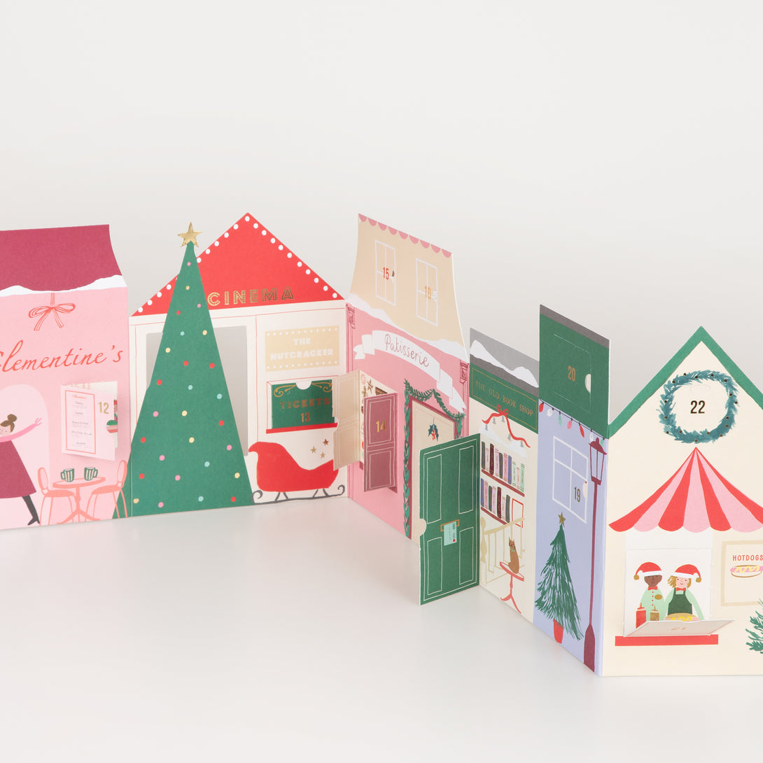 Our paper advent calendar is designed to look like Christmas street scene, with festive illustrations behind the windows and doors.