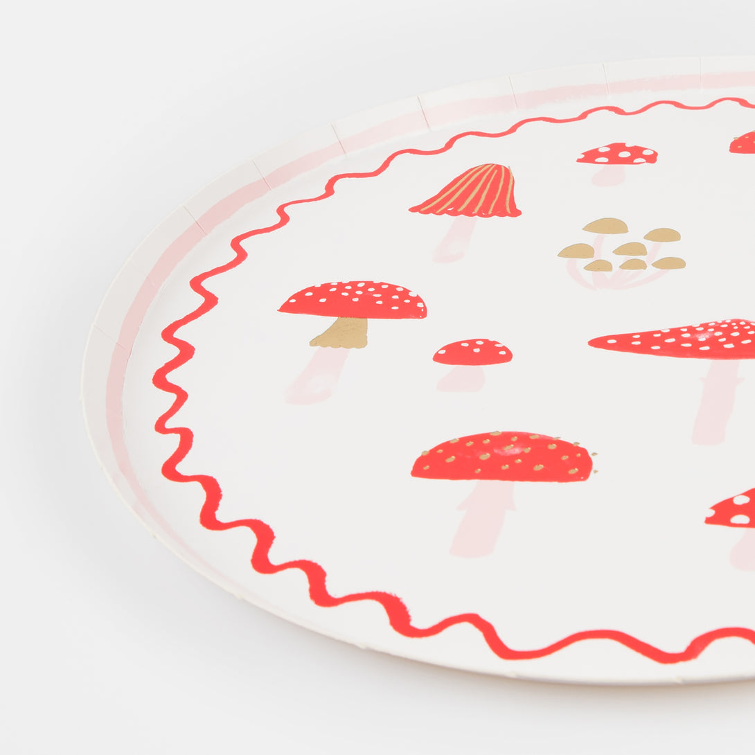 Our special Christmas party supplies include mushrooms and fairy designs on party plates, party napkins and cups, and a festive garland.