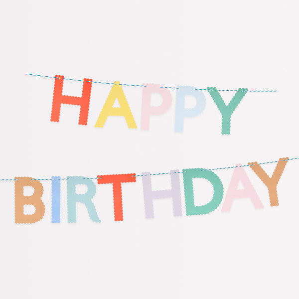 Our Happy Birthday garland, made with bright paper letters with scalloped details, adds a stylish and colorful decoration.