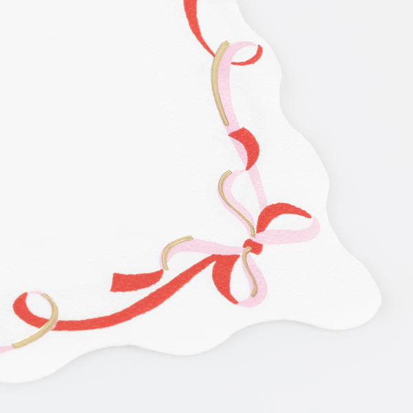 Our small paper napkins feature a modern ribbon bow design, in pink, red and gold, perfect for your Christmas dinner or a cocktail party. Image2