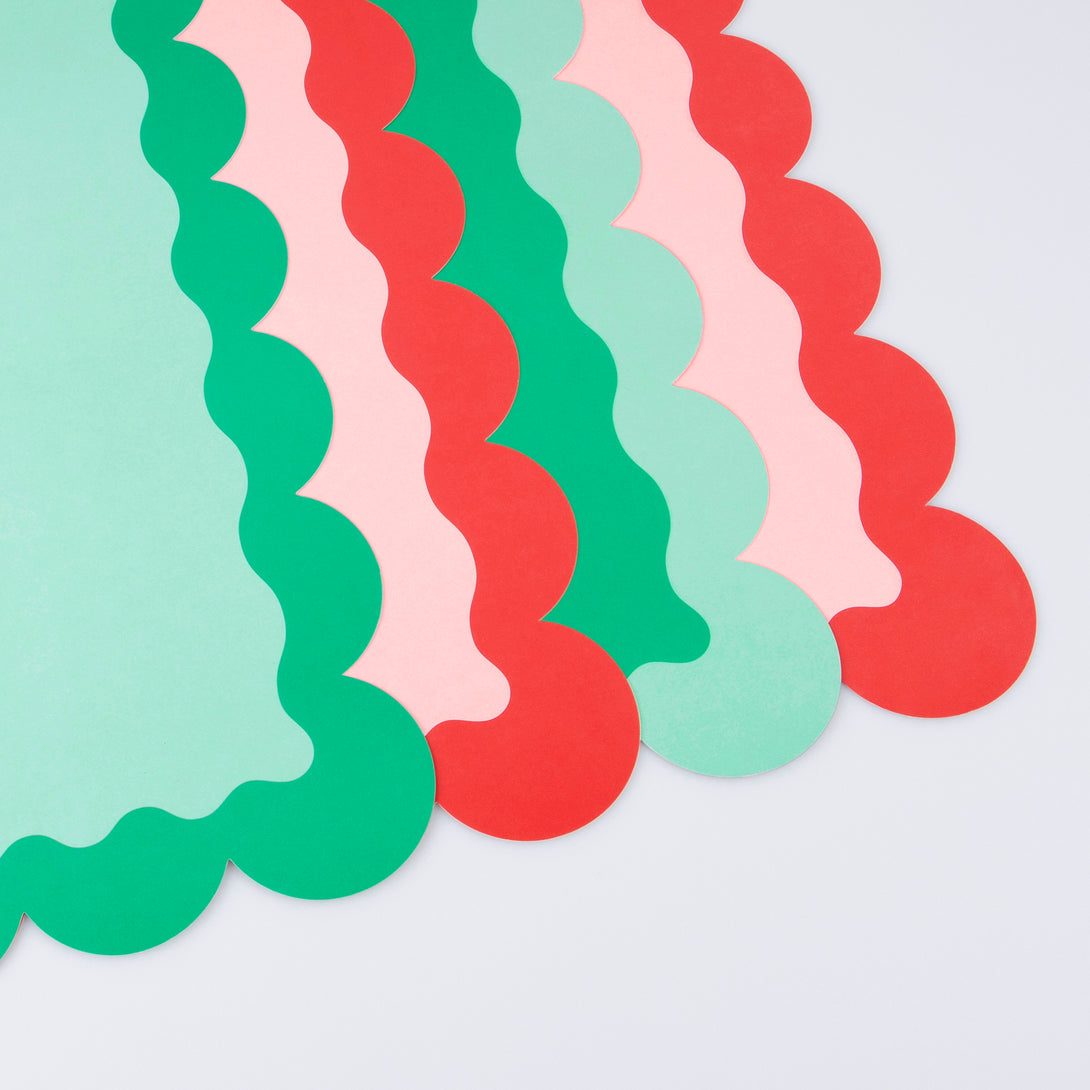 Our paper placemats are crafted in Christmas colors of red and green, with a modern pop of pink, and stylish scalloped edges.