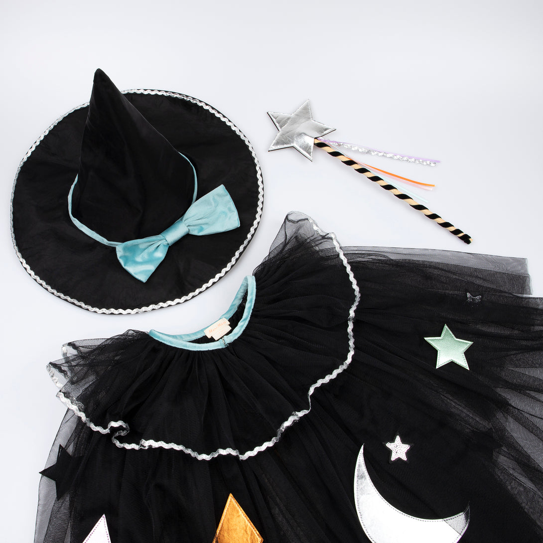 Our luxury witch costume set includes a tulle cape, an witch hat with a velvet bow and a colorful ribbon wand with a silver sequin star.