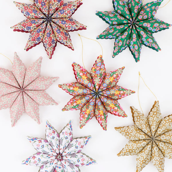 Our star decorations are designed to hang from your Christmas tree, featuring elegant Liberty print designs in rich festive colors. Image1