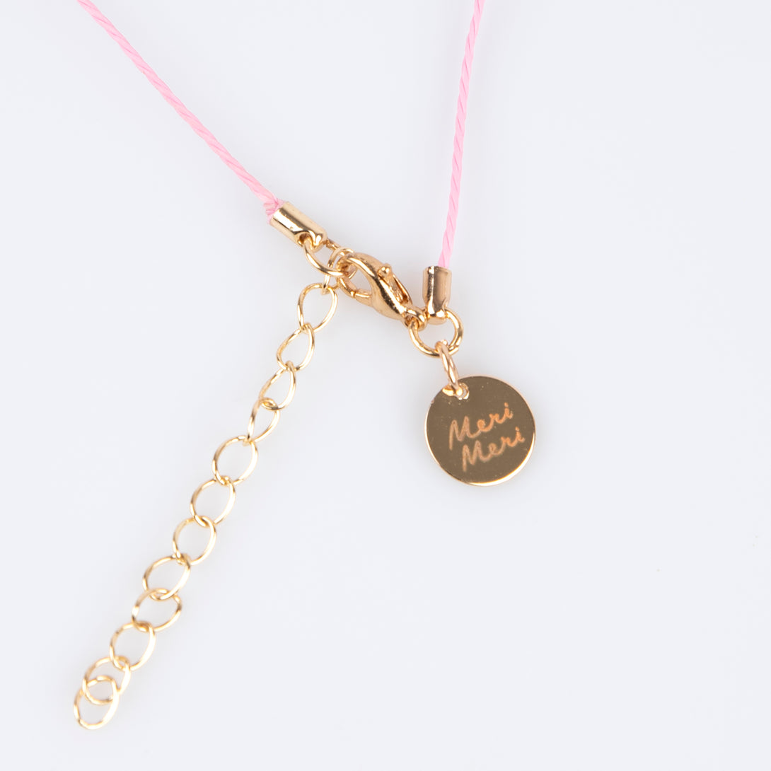 Our charms necklace is crafted with colorful enamel charms with a pink cord and gold tone lobster clasp, a pretty necklace for kids.