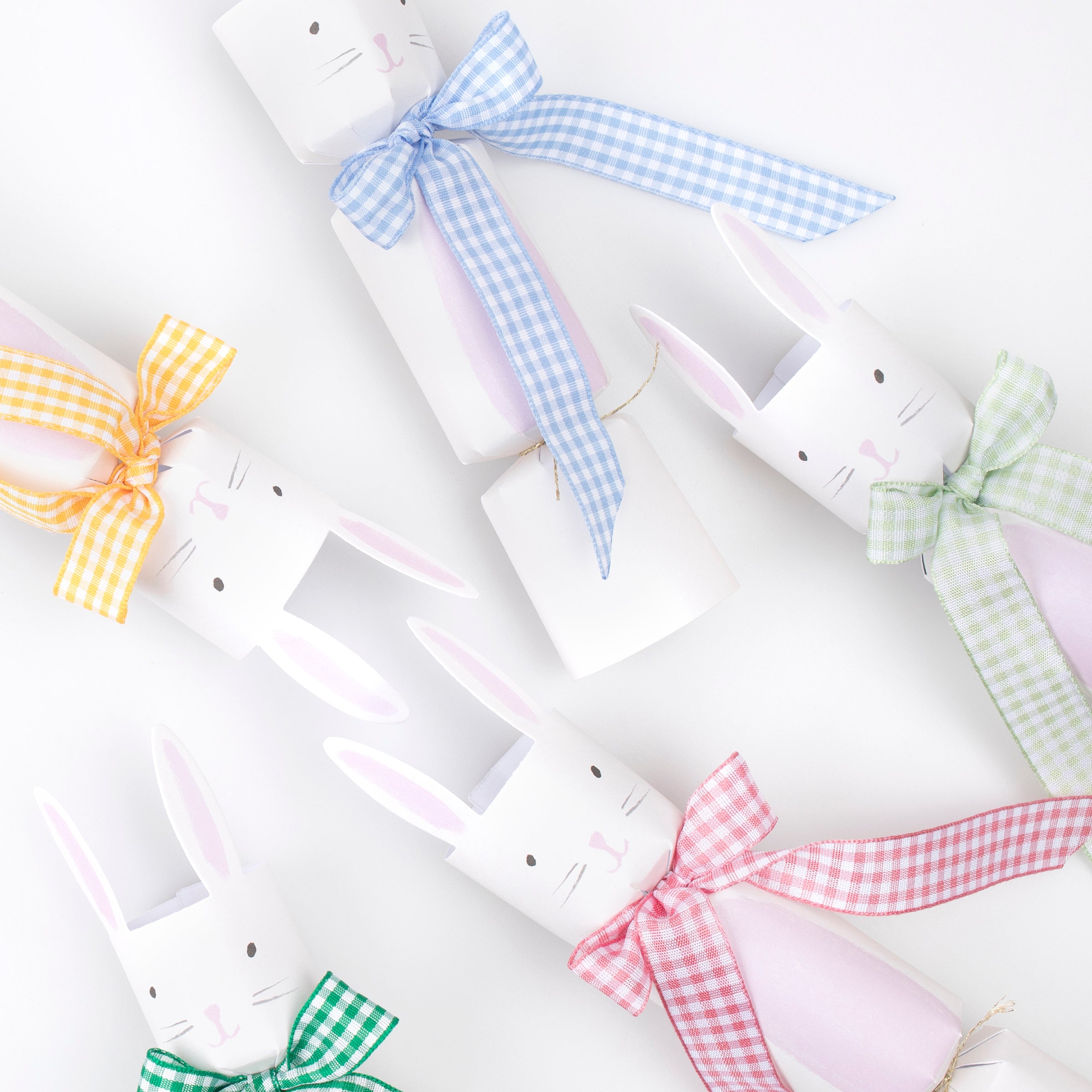 Our party crackers are crafted in the shape of bunnies, and contain mint tissue paper hats, erasers and a joke.