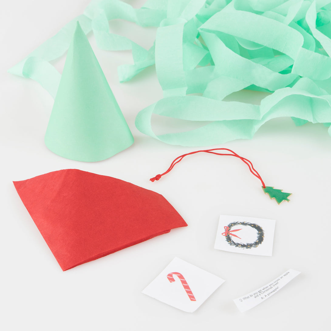 Our Christmas party favors make an amazing Christmas table decoration and include a party hat, jokes, stickers and an enamel charm.