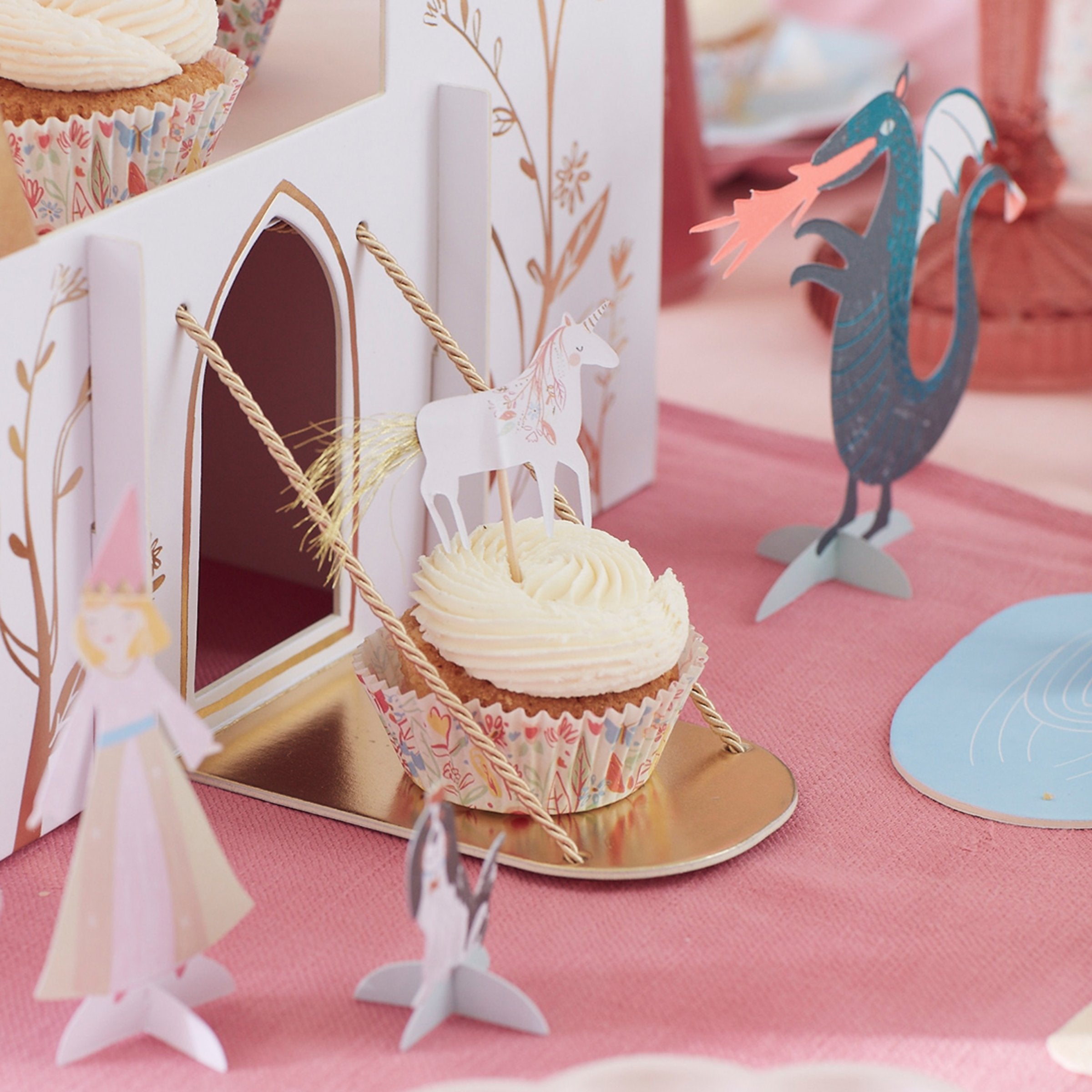 This princess cupcake kit includes carriage, flower, castle and unicorn cake toppers and coordinating cupcake cases.