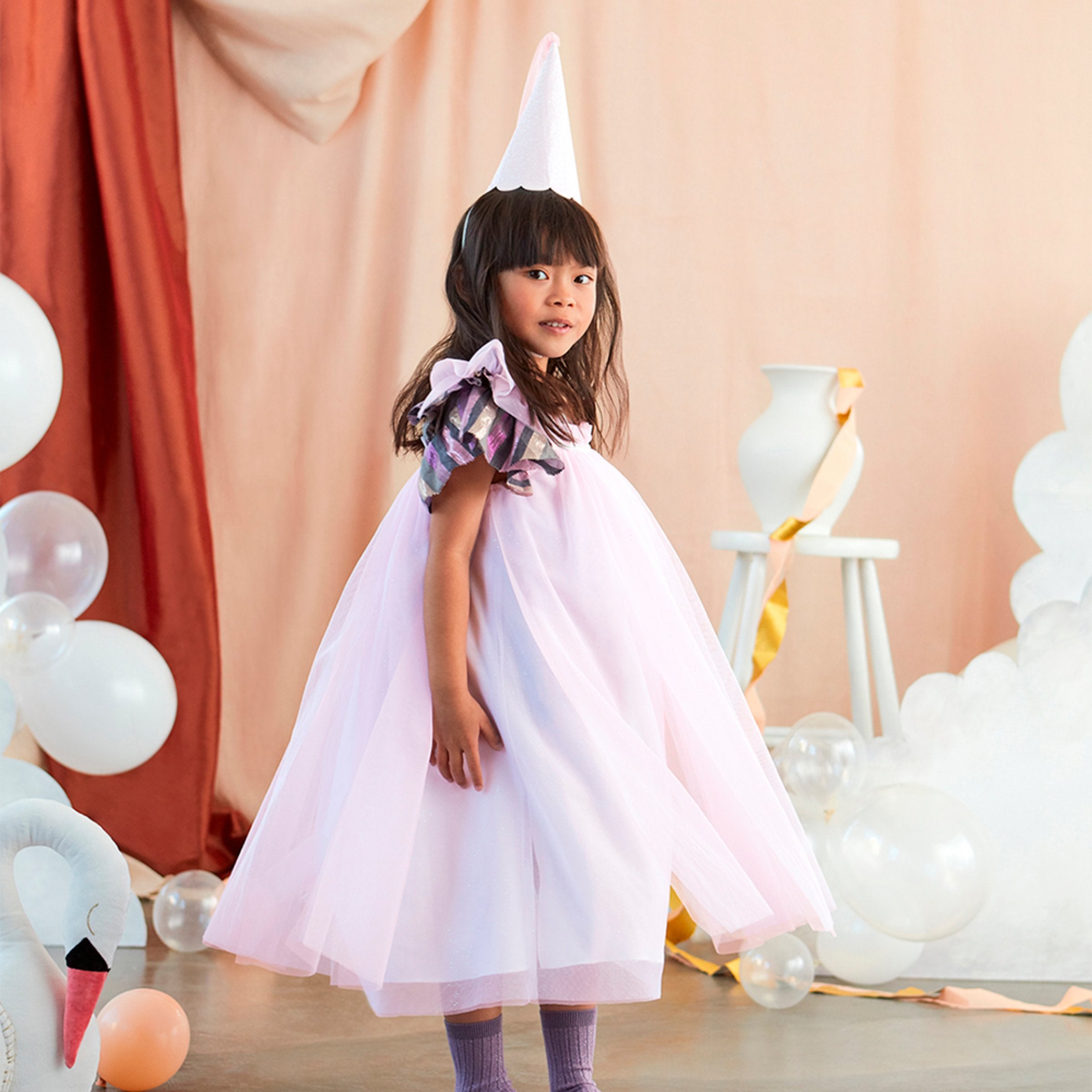 This costume, with a princess dress and hat with tassels, is perfect for a princess party.