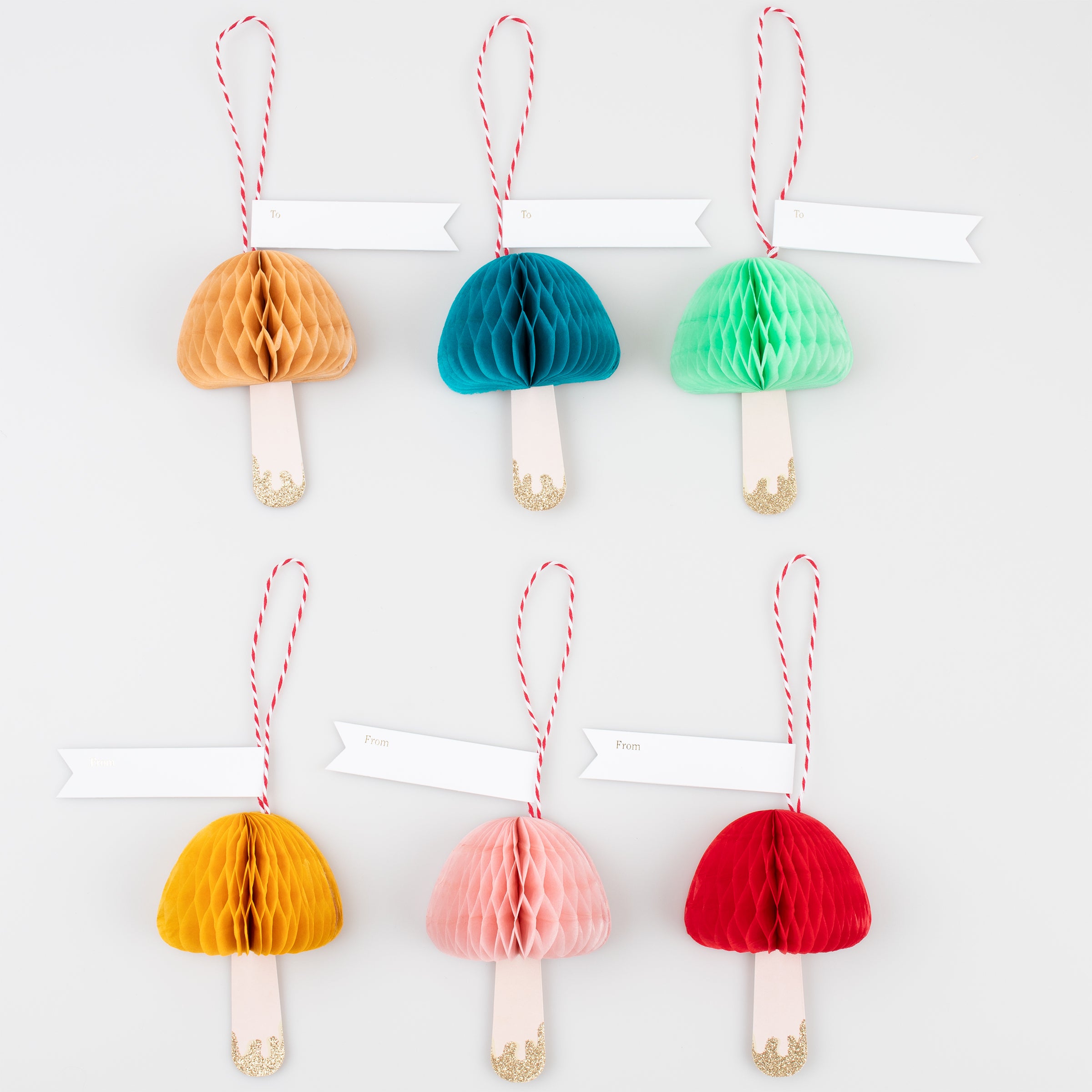 Our honeycomb decorations, in the shape of colorful mushrooms, also make wonderful tags for gifts.